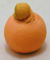 disgusting orange with mutant growth coming out of its navel
