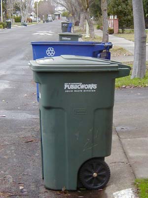 A trash can and a recycle can, turned from each other